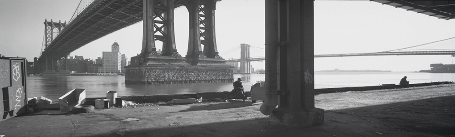 Jed Devine<br /> <em>Two Men Below the Manhattan Bridge,&nbsp;</em><br /> <em>from the FDR Drive, Manhattan, 1994</em><br /> 2 x 6.5", Platinum-palladium print on Japanese rice paper